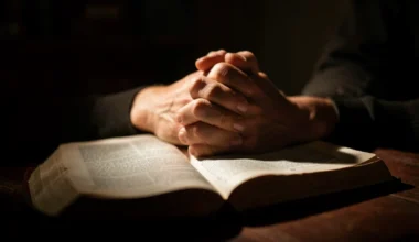 Hands clasped over a Bible, symbolizing hope and prayer for broken marriages.