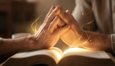 Man's hands in prayer over an open book, symbolizing 40 Powerful Blessing Prayers For Husband.